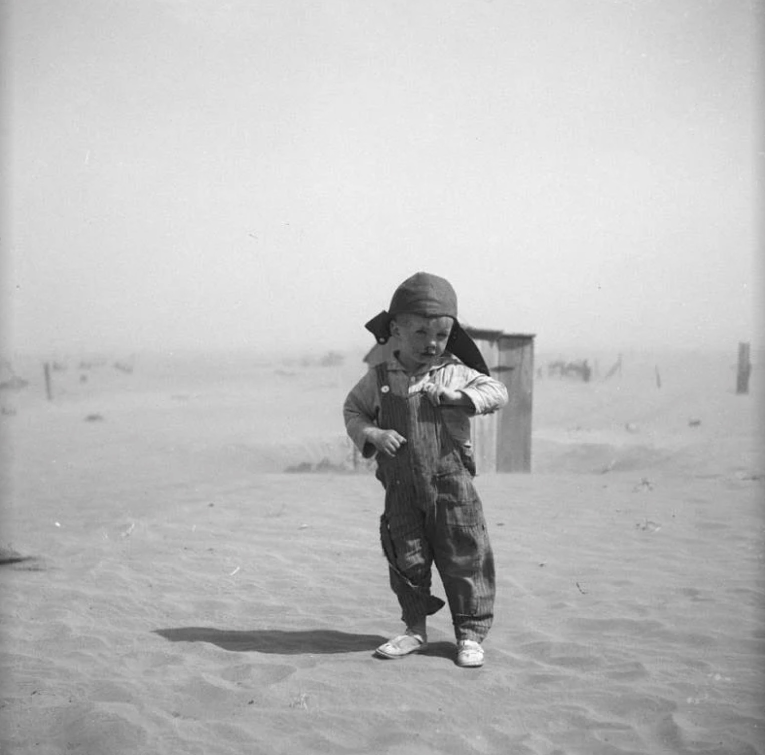 The young son of a farmer walks amid the dust in Cimarron County, Oklahoma 